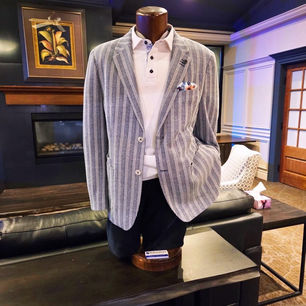 Striped sport coat over a white polo, displayed in the Buragina's fitting lounge